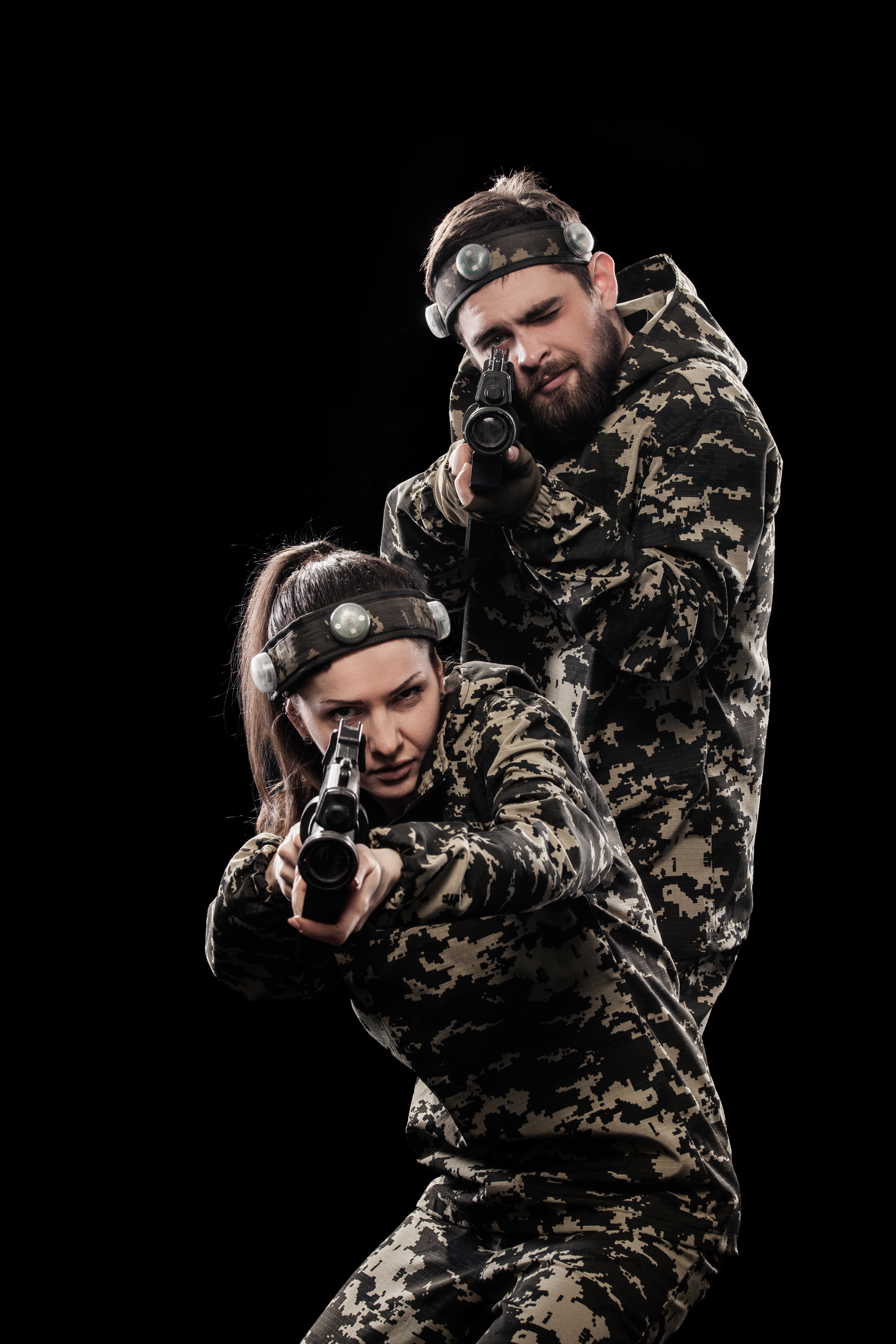 Heavily armed masked soldiers isolated on black background. Paint ball and laser tag sport games.